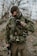 A satisfied customer wearing tactical gear in a natural setting.