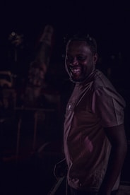 A softly lit candid moment from a lively event, highlighting genuine smiles and connection.