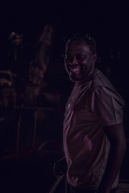 An intimate event shot capturing candid smiles under dim, ambient lighting.