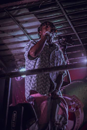 A dynamic photo of Diego Cardenas confidently speaking on stage with vibrant lighting.