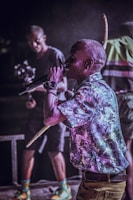A close-up of a rapper performing passionately on stage.