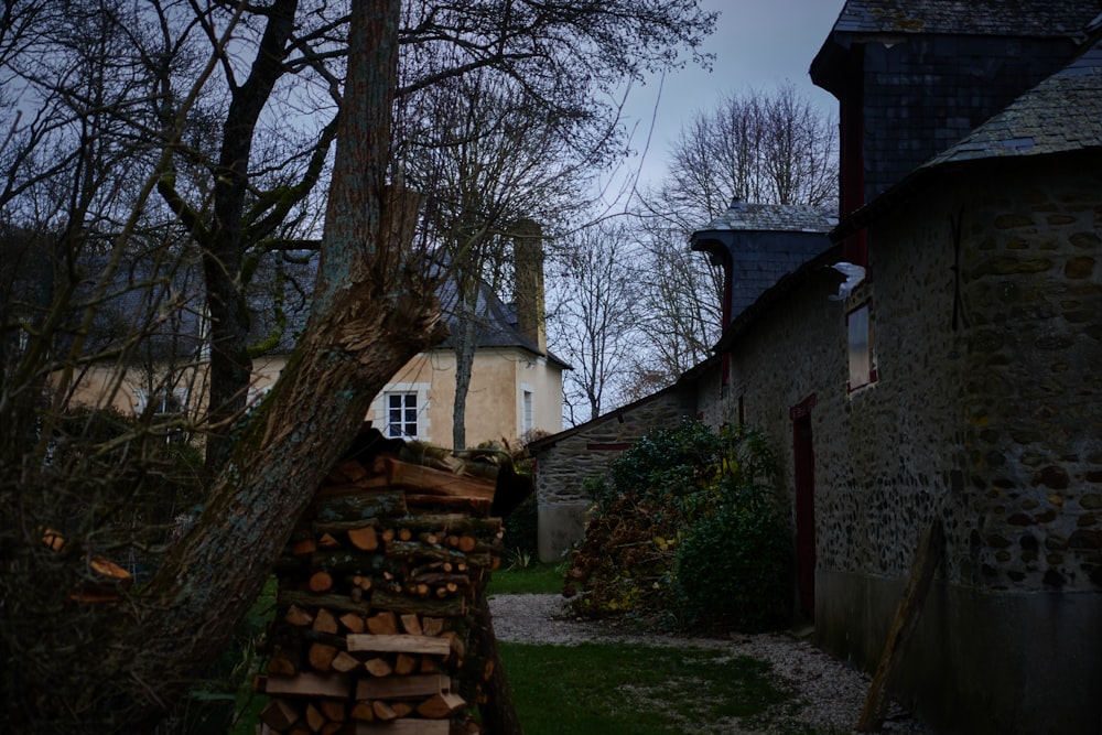 a pile of wood sitting next to a building