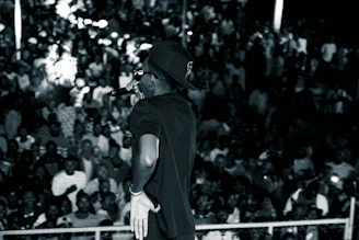 A charismatic megastar MC engaging an enthusiastic crowd on stage.