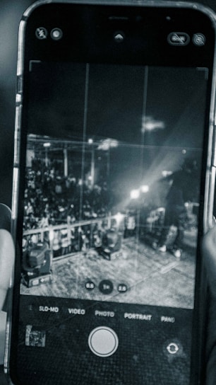A close-up of a smartphone scanning a concert ticket with a glowing blockchain verification overlay.