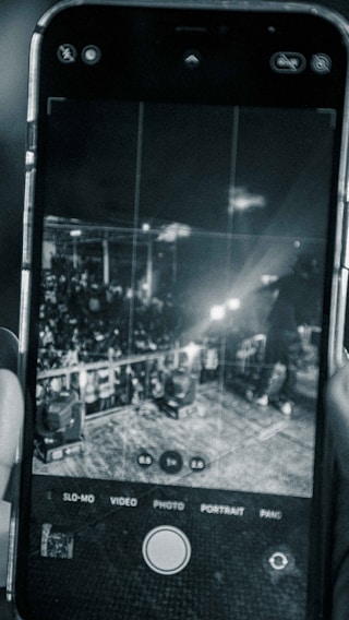 A close-up of a smartphone scanning a concert ticket with a glowing blockchain verification overlay.