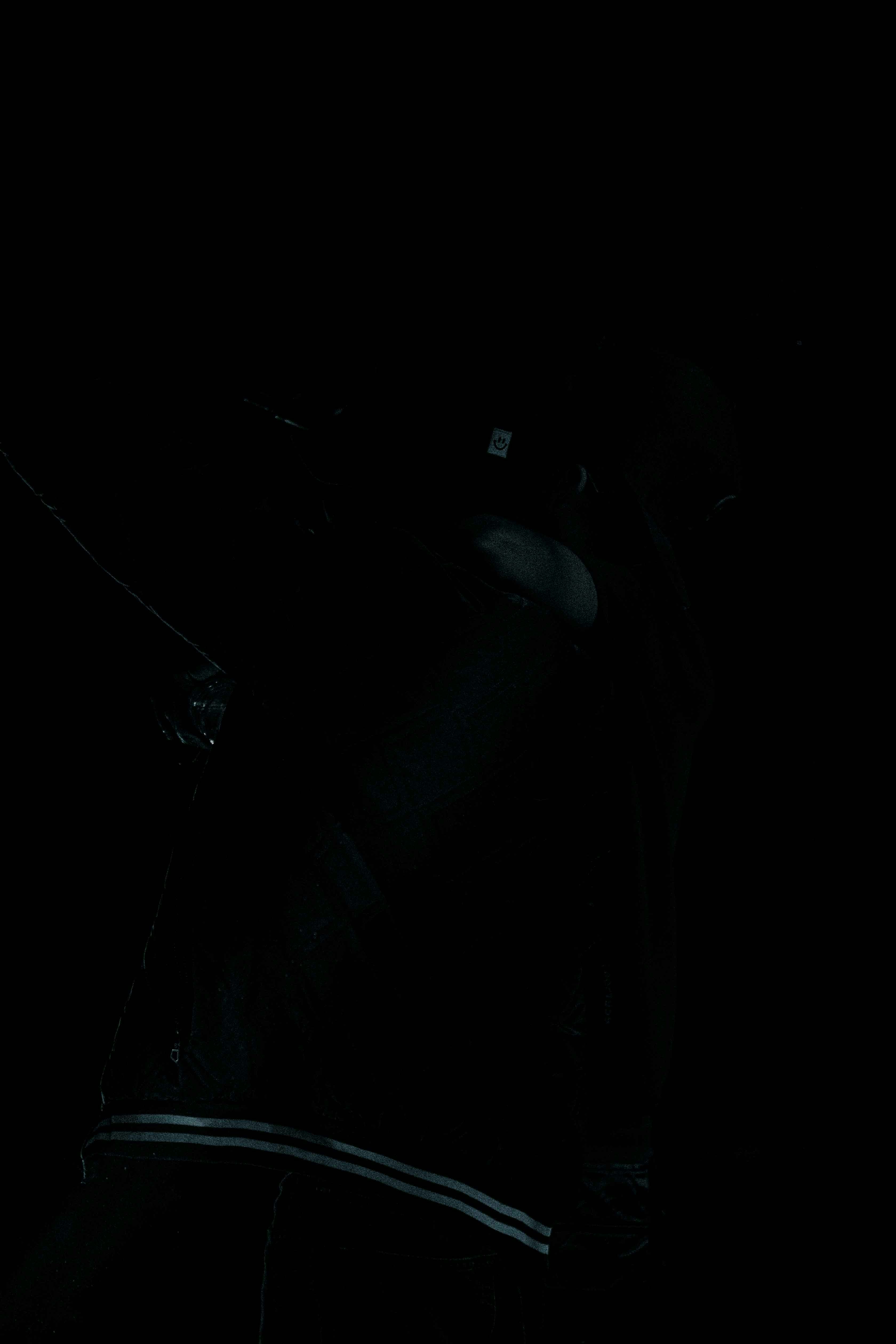 a man holding a cell phone in the dark