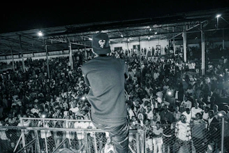 A vibrant photo of a motivational speaker engaging a diverse, enthusiastic audience in a large conference hall.