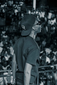 A portrait of a confident leader standing in front of a community gathering, engaging with the audience.