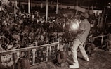 Willy Bula engaging with fans at an energetic outdoor concert