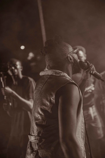 a man standing on a stage holding a microphone
