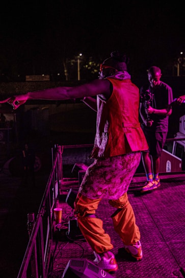 A vibrant image of Pezera performing on stage.