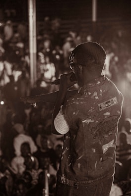 A singer with a vintage microphone captivating a small crowd.