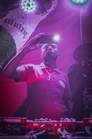 Photo of Mohamed Aden filming a TikTok video with vibrant lighting.