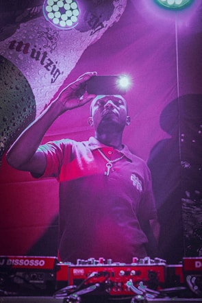 Photo of Mohamed Aden filming a TikTok video with vibrant lighting.