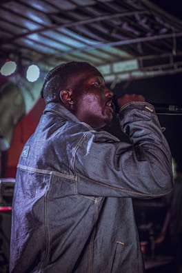 Close-up of danken smiling and holding a microphone in an intimate venue