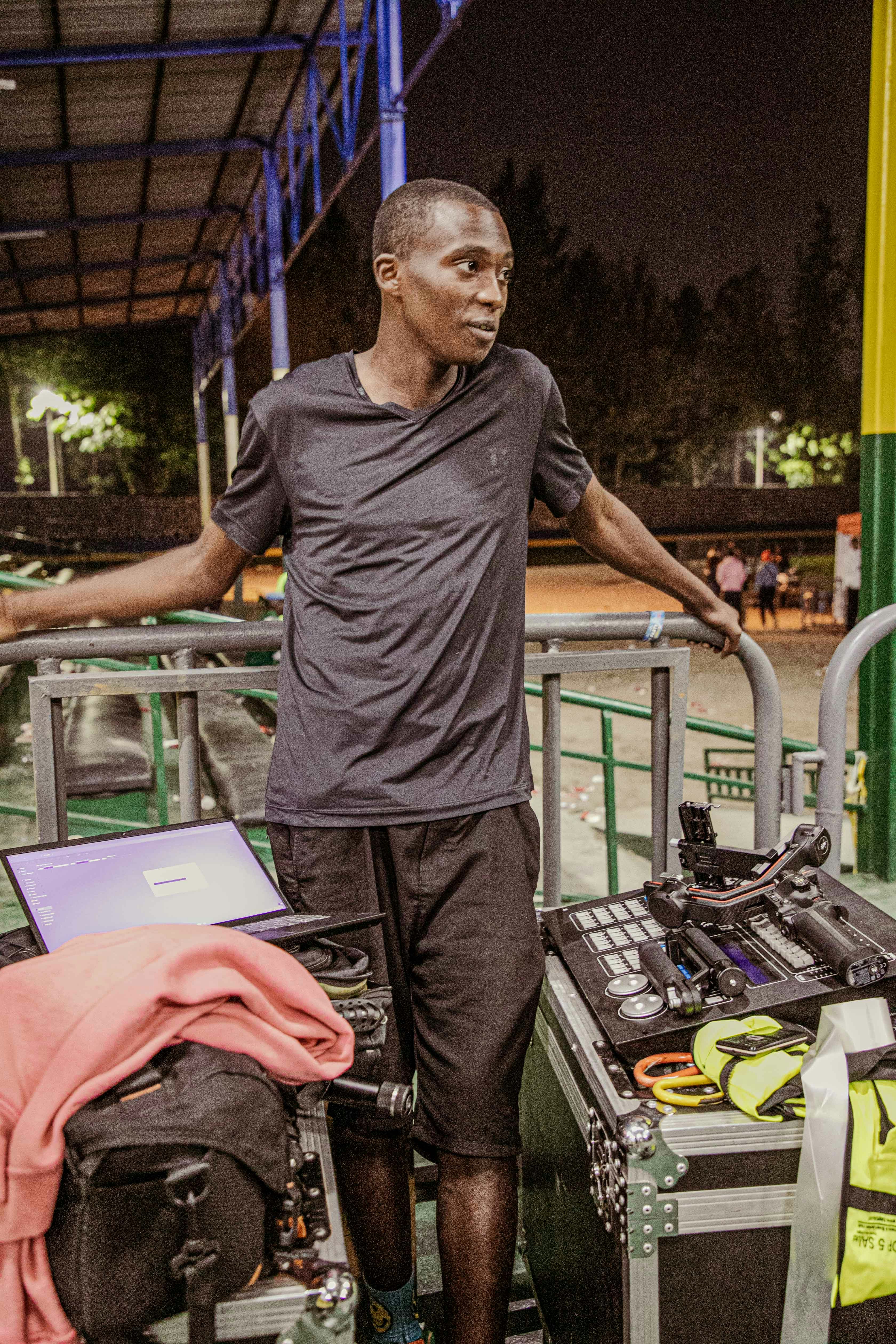 a man standing in front of a luggage cart