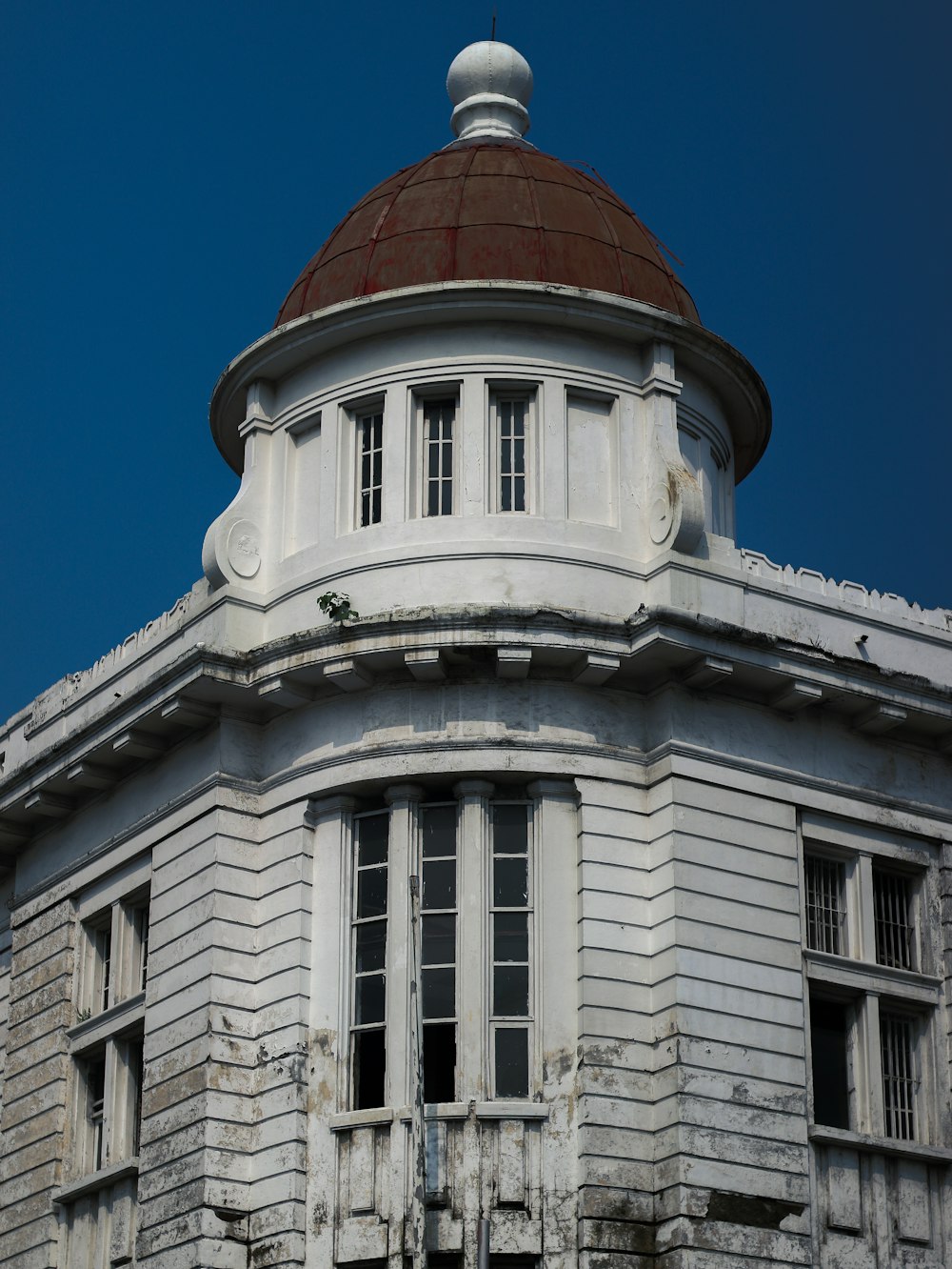 an old white building with a red roof