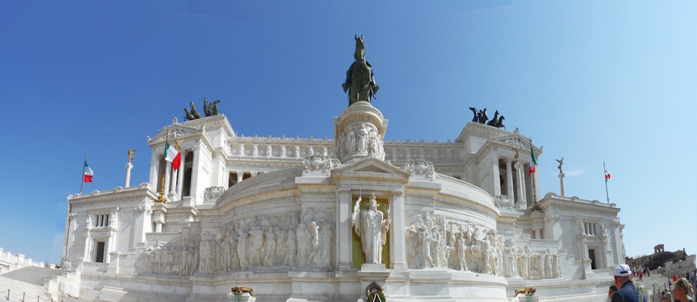 a large white building with a statue on top of it