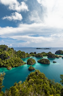 a group of small islands in the middle of a body of water