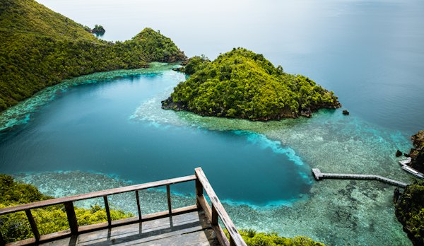 An aerial view of a small island in the middle of the ocean — Raja Ampat, Indonesia