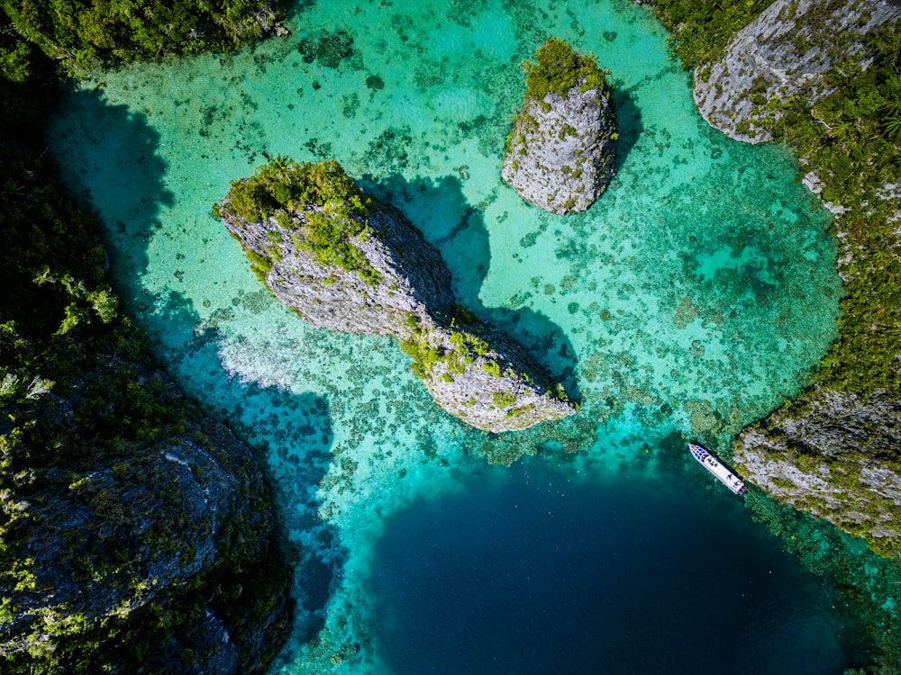 an aerial view of a lake surrounded by rocks