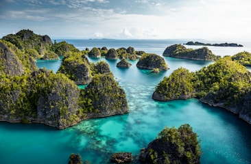 an aerial view of a body of water surrounded by rocks