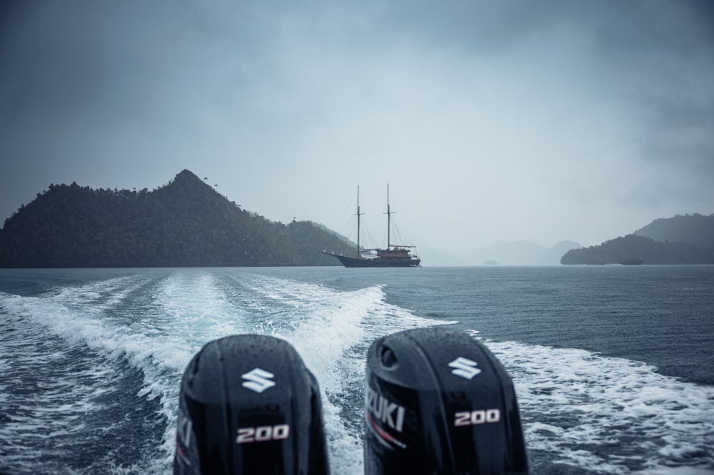 a couple of boats traveling across a large body of water