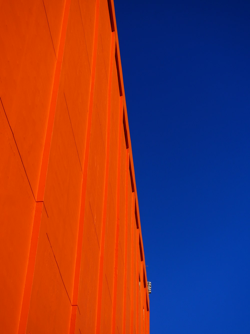 an orange building with a blue sky in the background