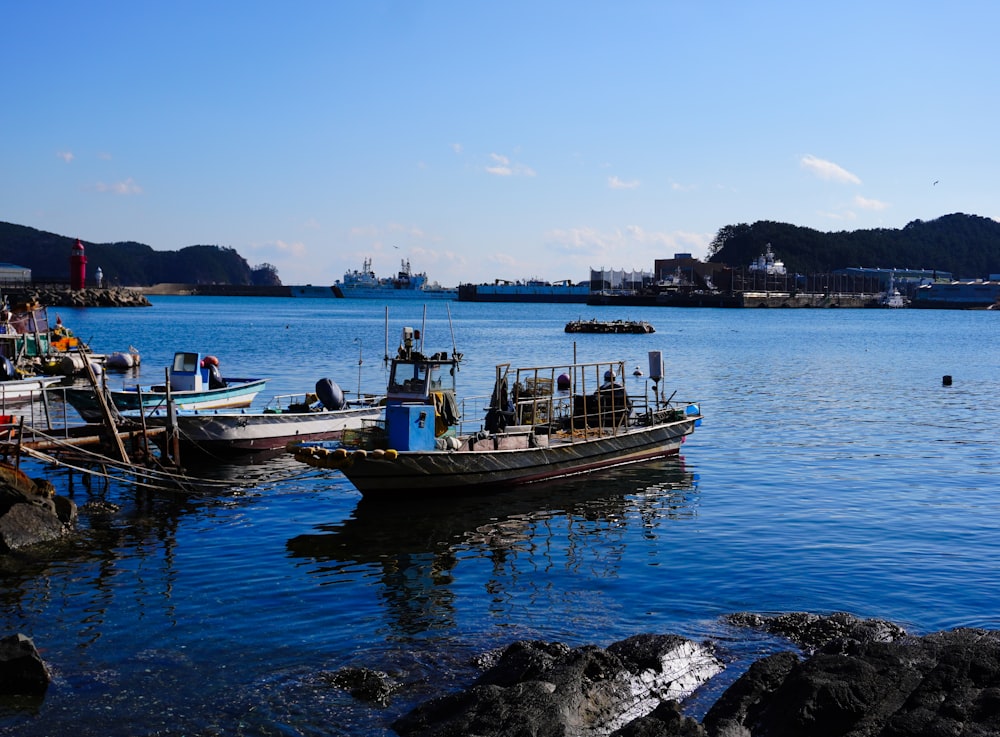 a group of boats floating on top of a body of water