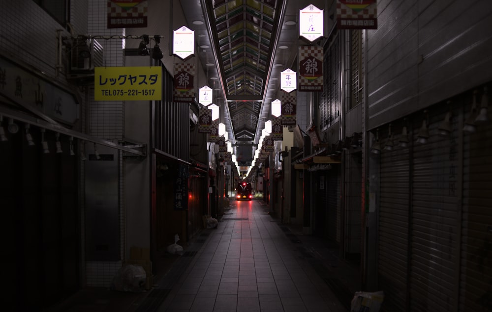 a long narrow hallway with lights hanging from the ceiling