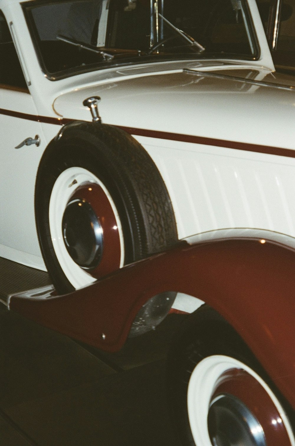 a white and red car parked in a garage