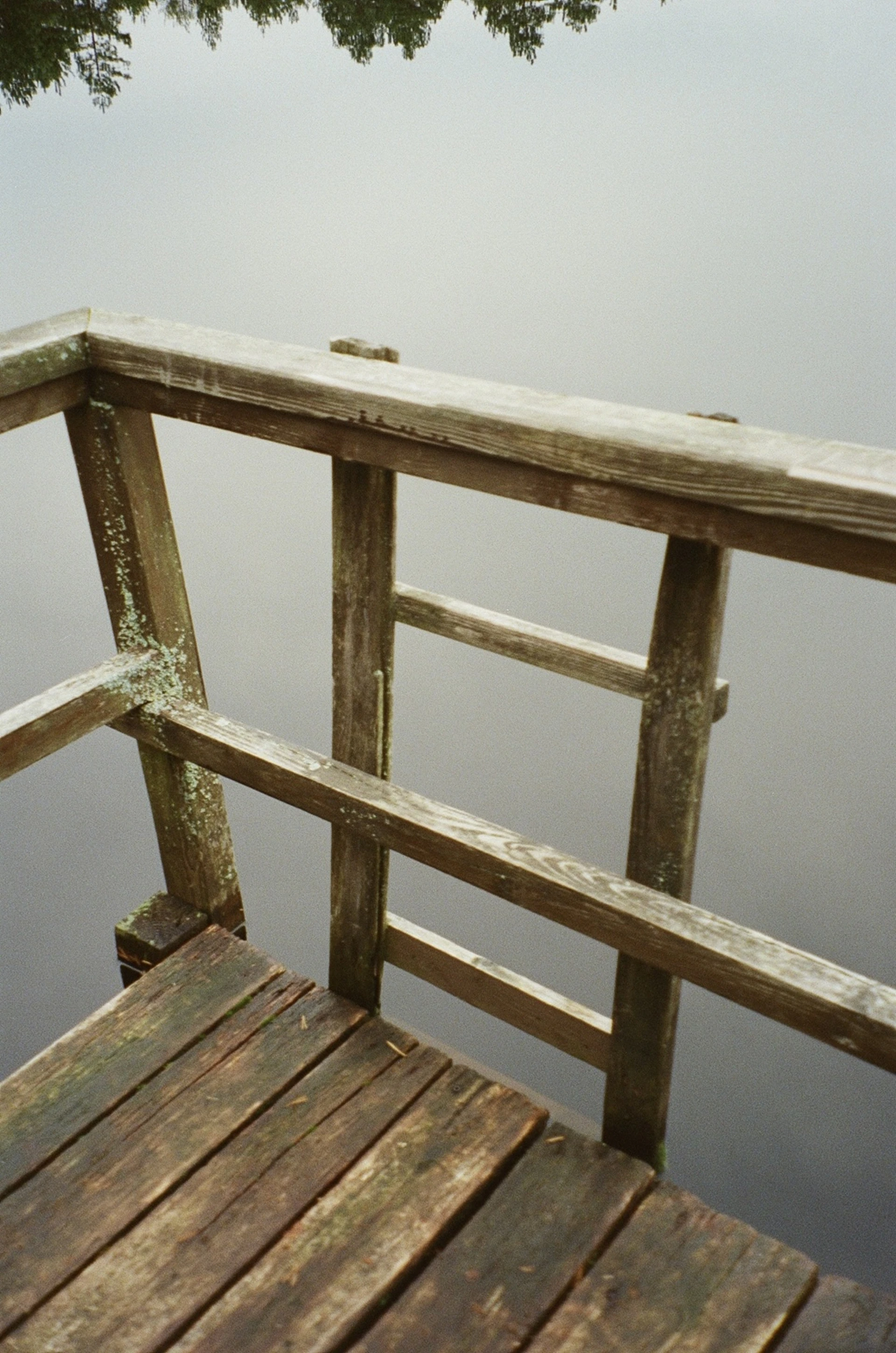 Before and after shot of a weathered wooden deck transformed by Chris' crystal clean powerwashing in Smithfield, NC.