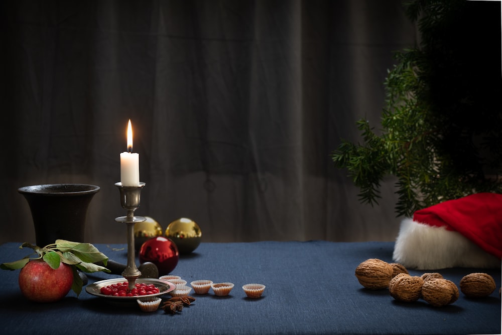 a table topped with a plate of food and a candle