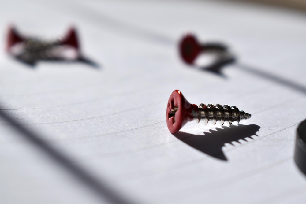 a bunch of screws laying on top of a piece of paper