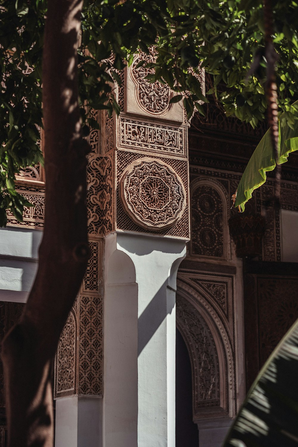 a tall white pillar sitting under a tree