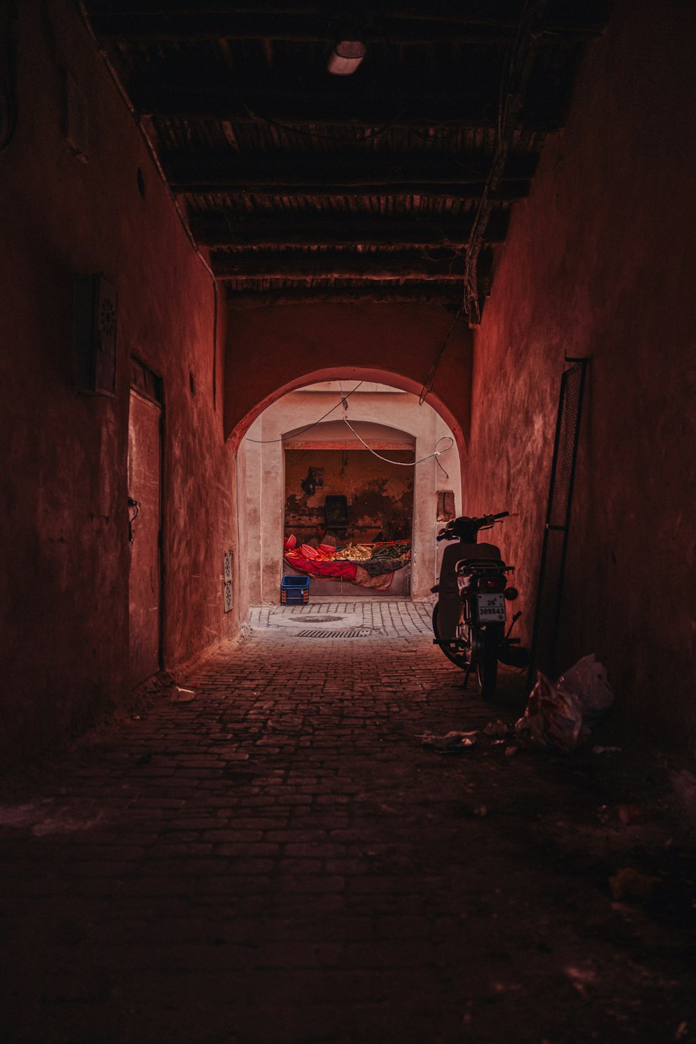 a motorcycle is parked in a narrow alley