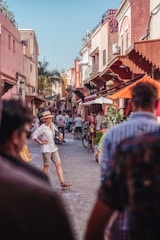 A vibrant neighborhood street with shops and apartments bustling with life.