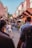 A vibrant market street bustling with tourists and colorful local shops.