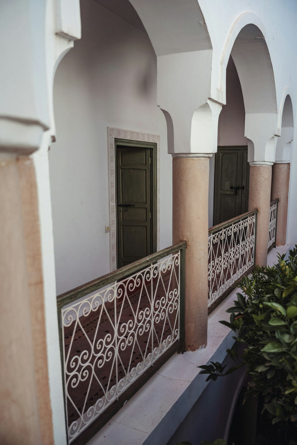 a white building with a green door and window