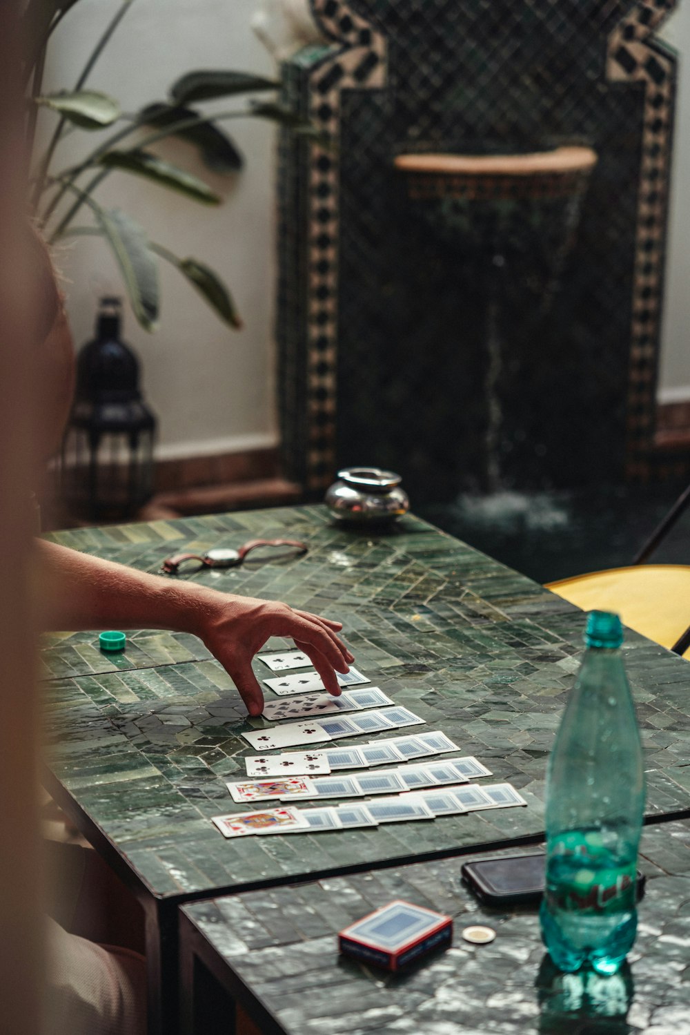a person is playing a card game on a table