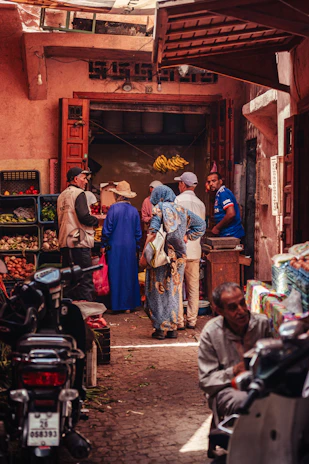 A traveler chatting with a local vendor in a bustling Indonesian market.
