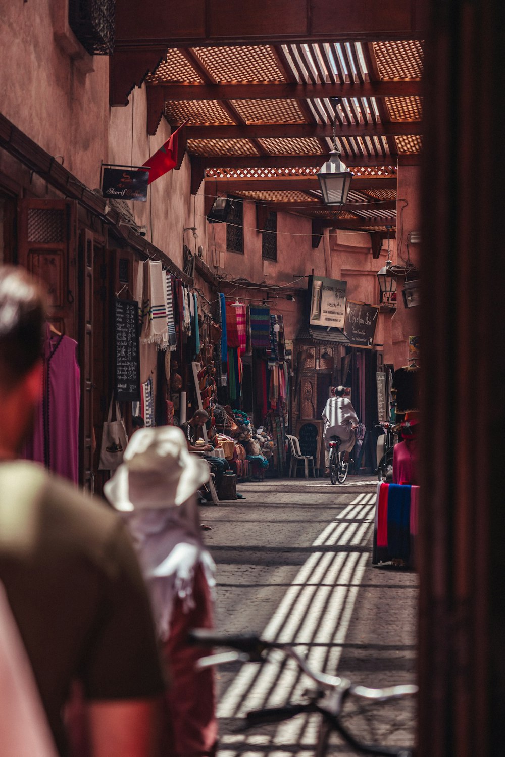 a man walking down a street next to a building