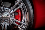 a close up of a wheel on a red sports car