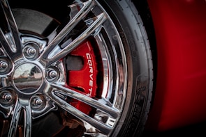 a close up of a wheel on a red sports car