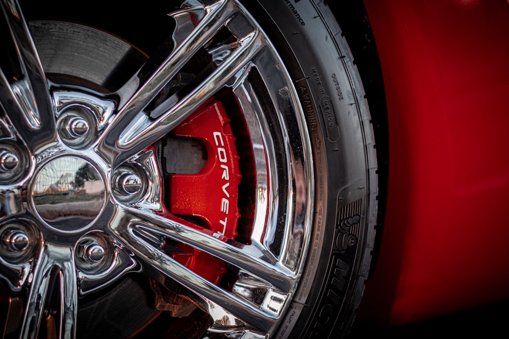 a close up of a wheel on a red sports car