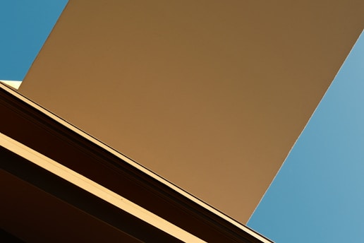 A stunning architectural photograph capturing modern lines against a blue sky.