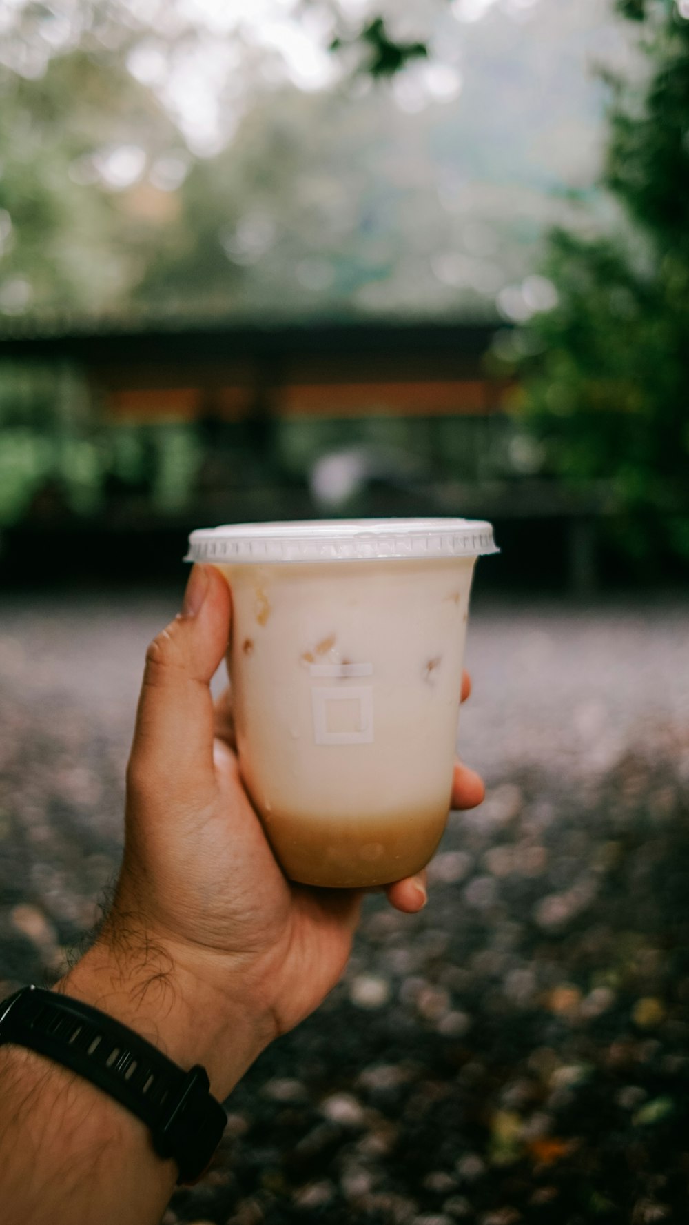 a person holding a cup of coffee in their hand