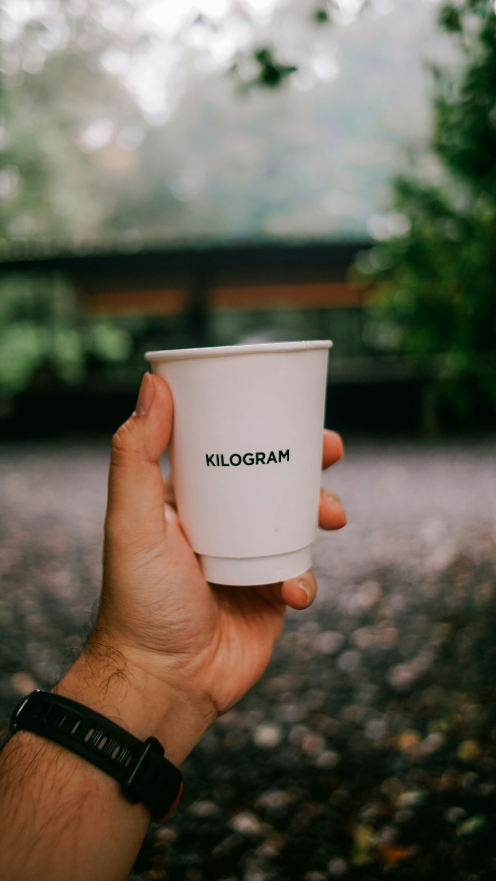 a person holding a cup with a name on it