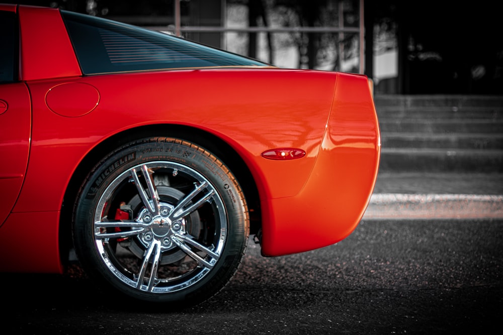 a red sports car parked in a parking lot