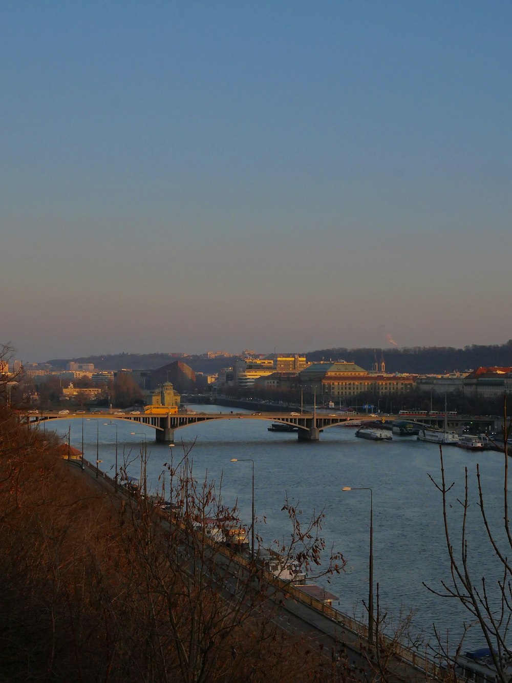 a body of water with a bridge in the background